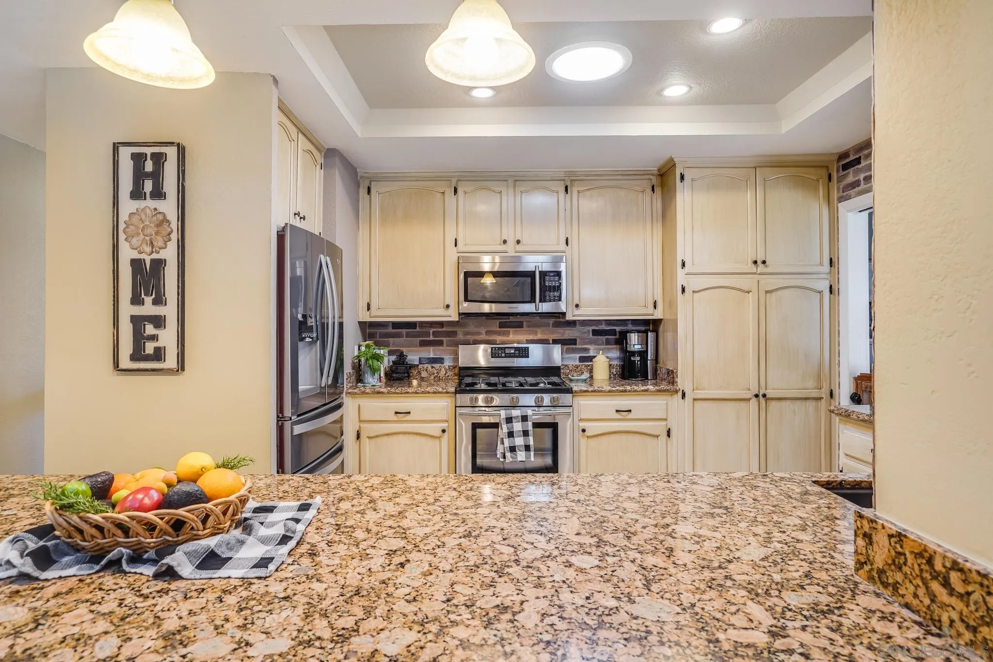 3764 Avocado Boulevard La Mesa, CA 91941 - Photo 22 of 66 a kitchen with stainless steel appliances kitchen island granite countertop a refrigerator stove and sink