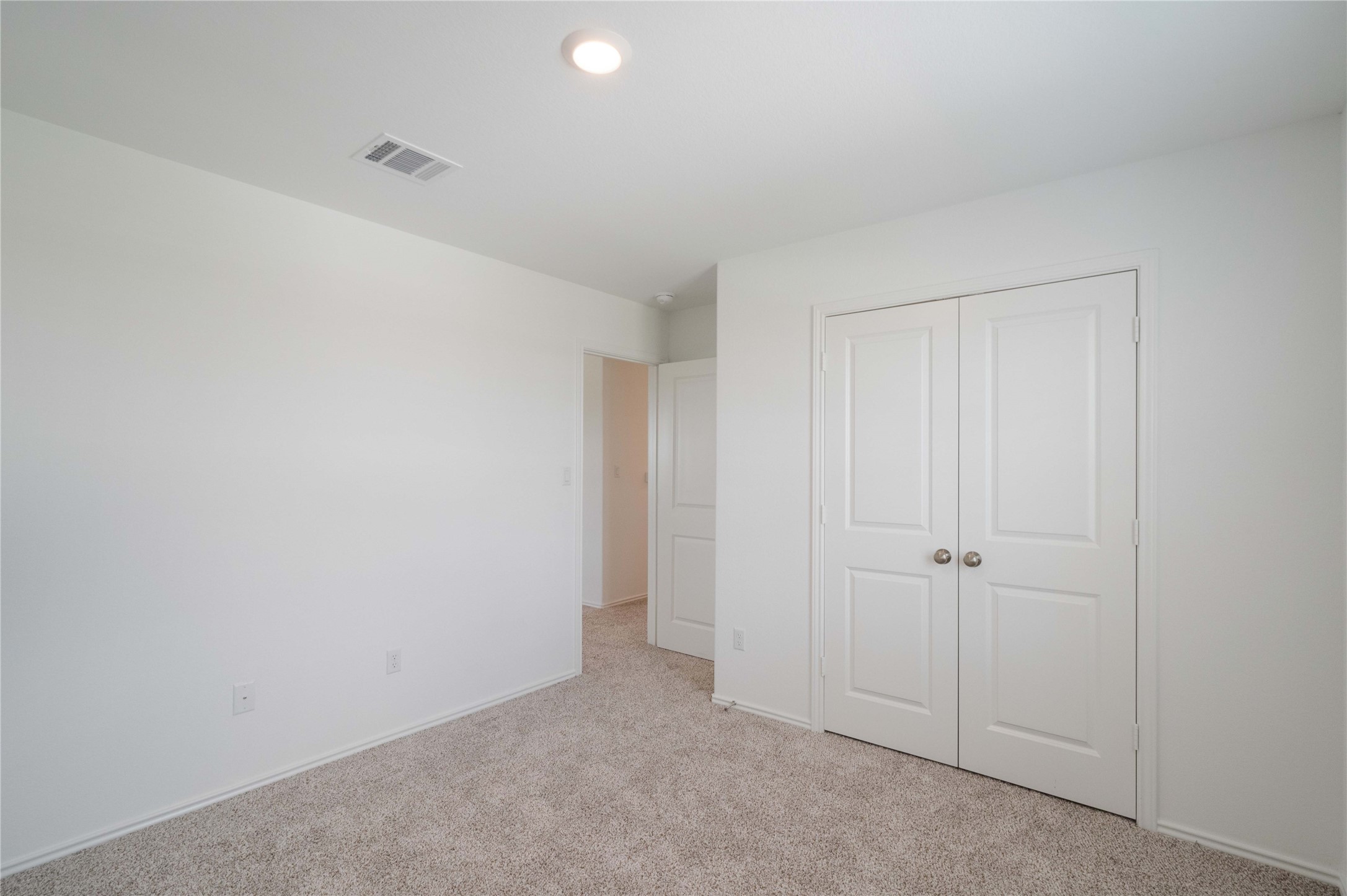 932 Mallow Road Leander, TX 78641 - Photo 18 of 40 Room featuring light grey carpeting, white walls, and a recessed ceiling light