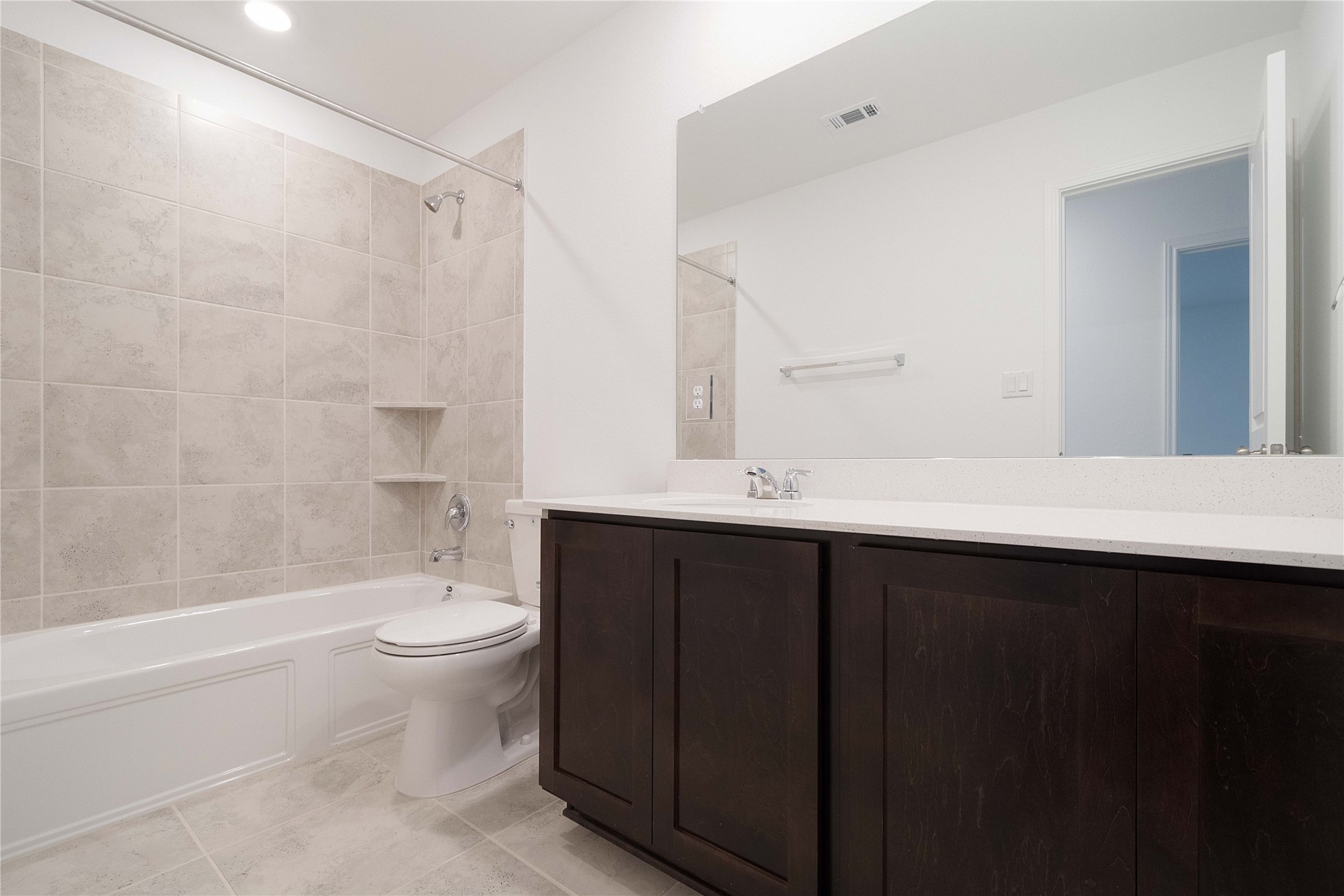 932 Mallow Road Leander, TX 78641 - Photo 19 of 40 a bathroom with a bathtub sink vanity mirror and toilet