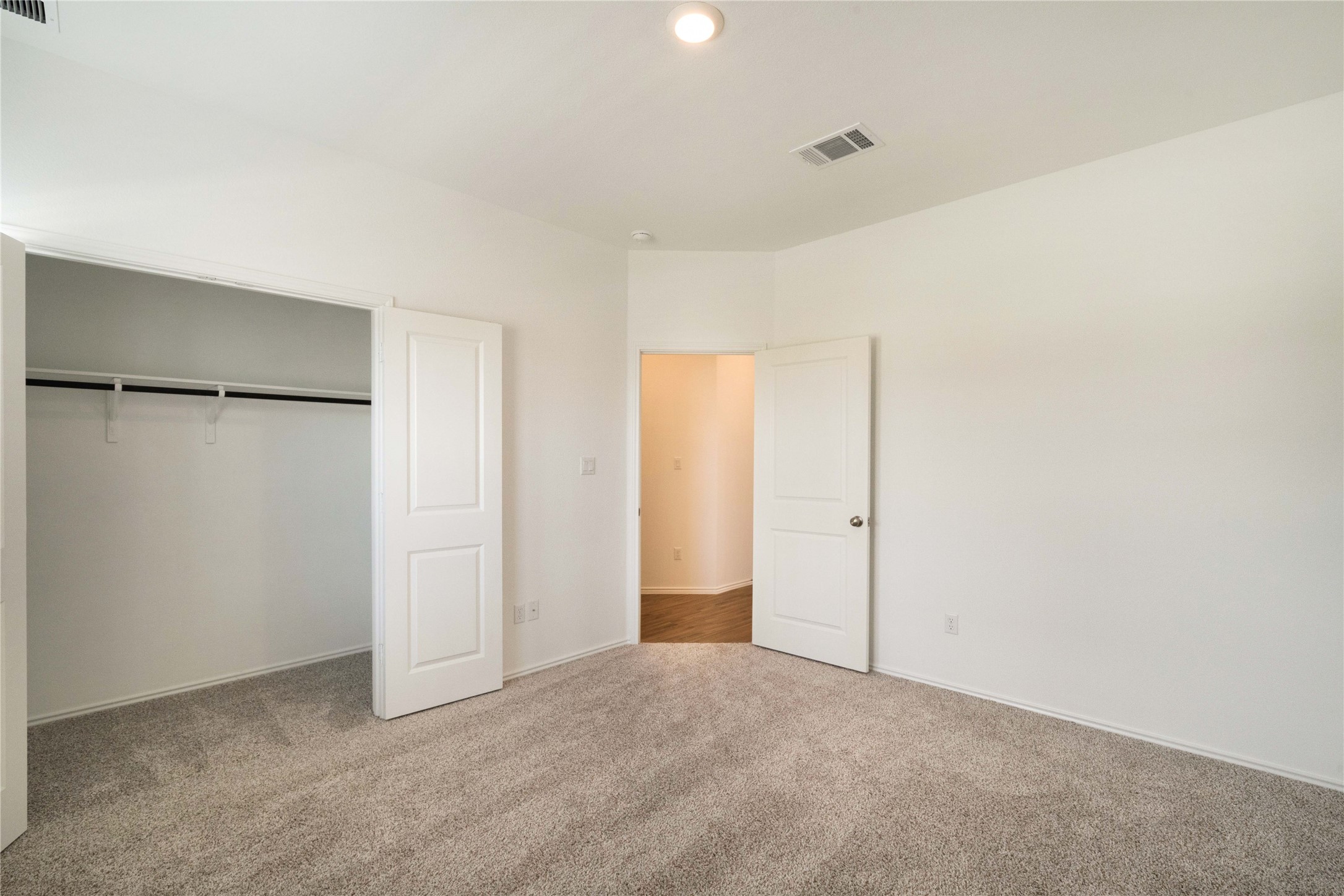 932 Mallow Road Leander, TX 78641 - Photo 22 of 40 Spacious room with plush gray carpeting, white walls, and a recessed ceiling light