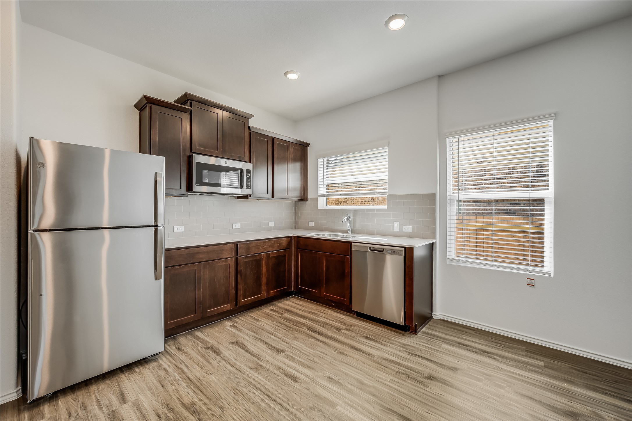 932 Mallow Road Leander, TX 78641 - Photo 26 of 40 a kitchen with stainless steel appliances granite countertop a refrigerator and a stove top oven