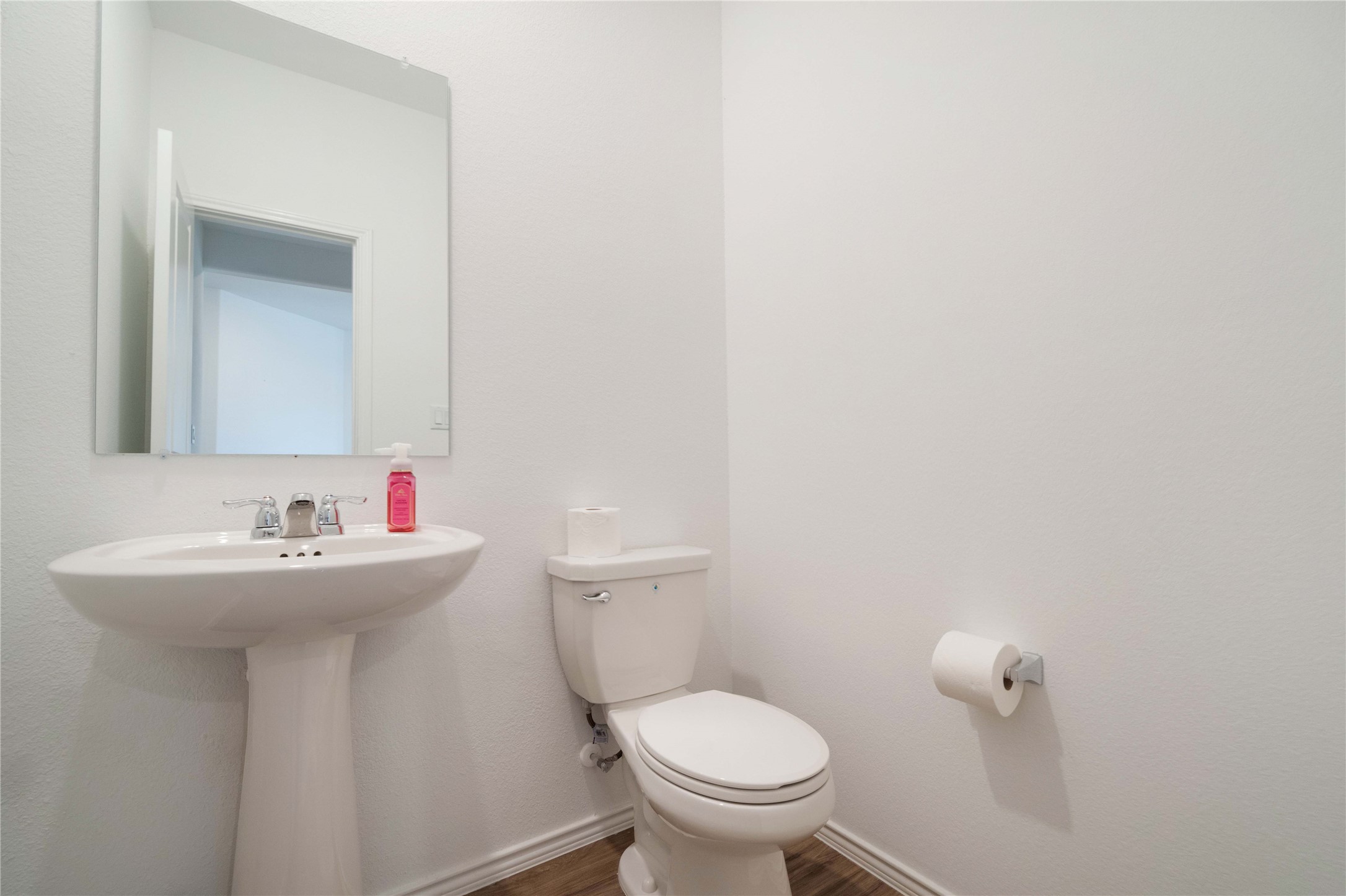 932 Mallow Road Leander, TX 78641 - Photo 30 of 40 a bathroom with sink a toilet and mirror