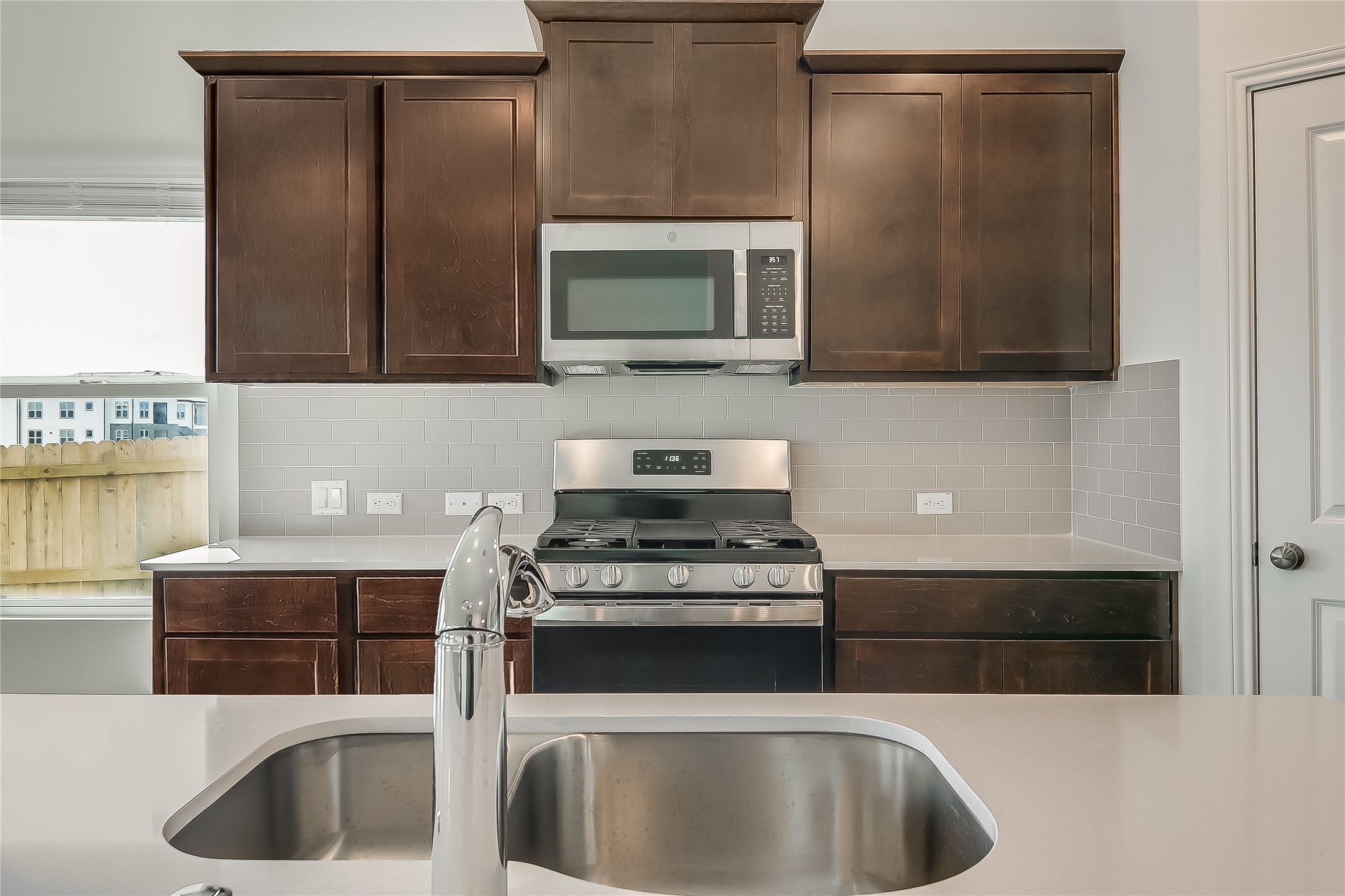 932 Mallow Road Leander, TX 78641 - Photo 4 of 40 a kitchen with a sink and a stove top oven