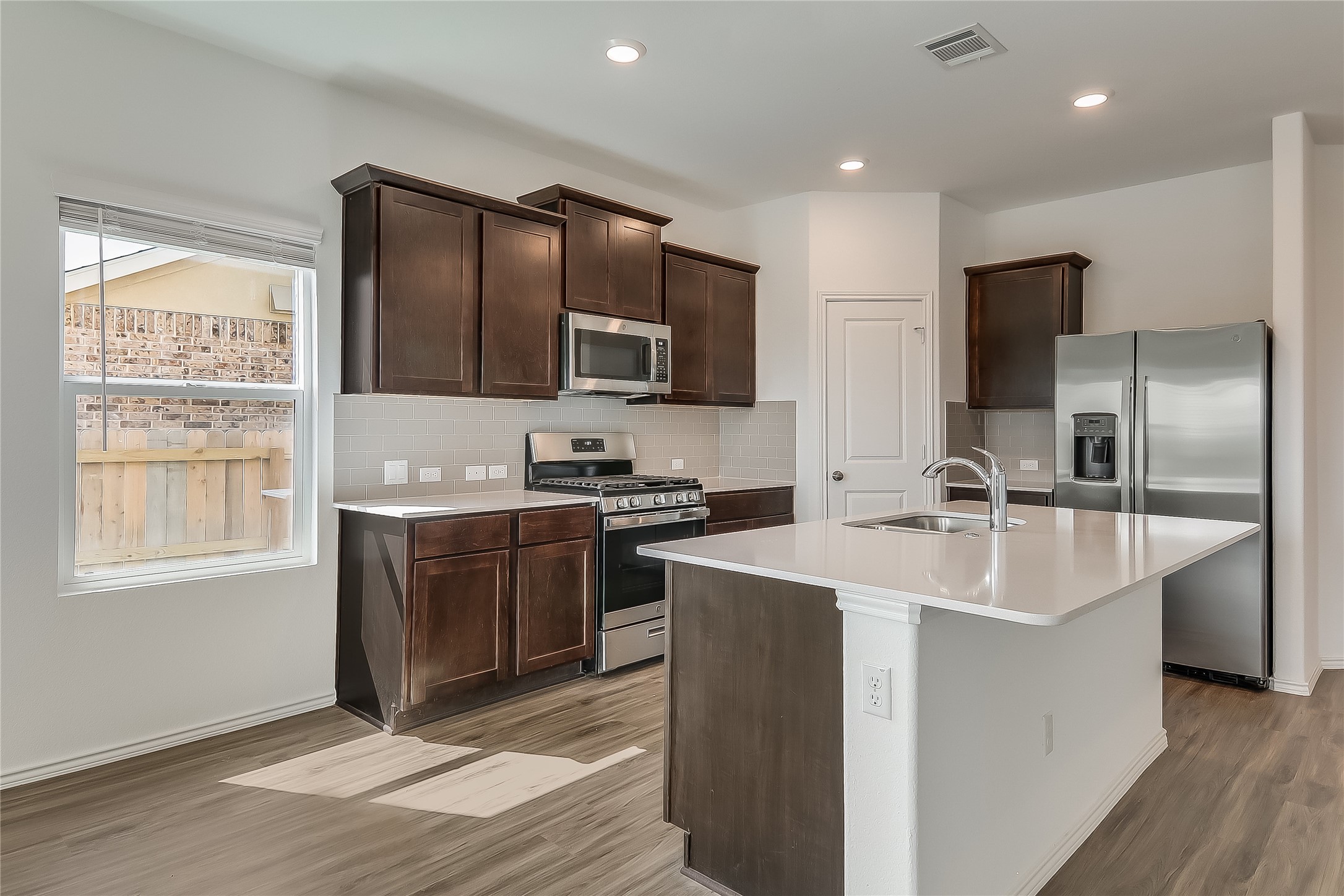 932 Mallow Road Leander, TX 78641 - Photo 5 of 40 a kitchen with stainless steel appliances granite countertop a sink stove and refrigerator
