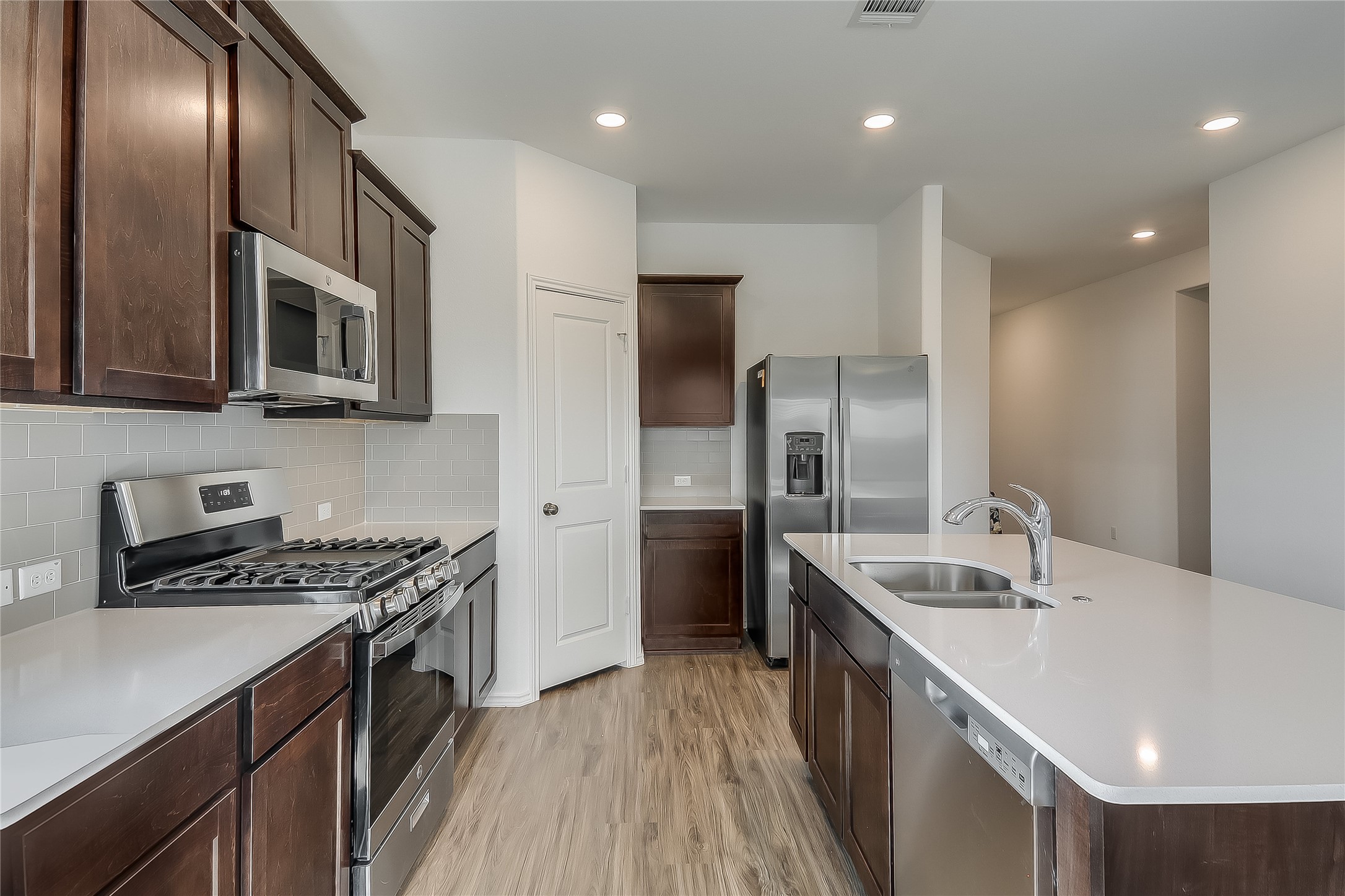 932 Mallow Road Leander, TX 78641 - Photo 6 of 40 a kitchen with stainless steel appliances granite countertop a sink a stove and a refrigerator