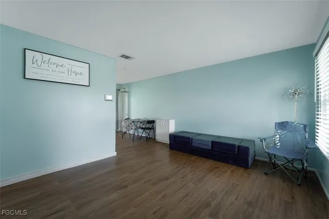 a view of workspace with wooden floor and furniture