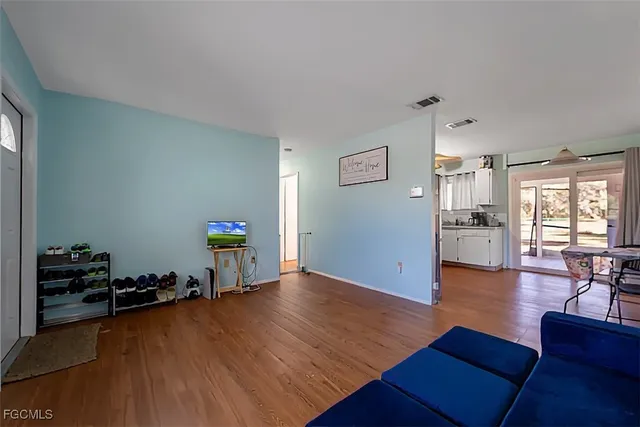 a living room with furniture and a wooden floor