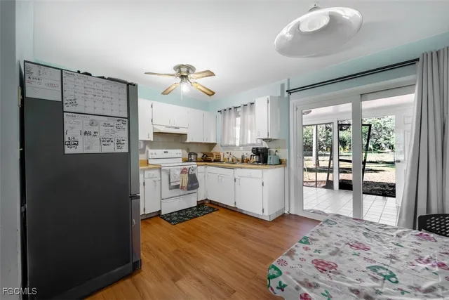 a kitchen with stainless steel appliances granite countertop a refrigerator sink and cabinets