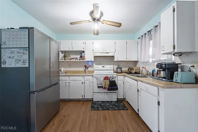 a kitchen with refrigerator cabinets and a sink