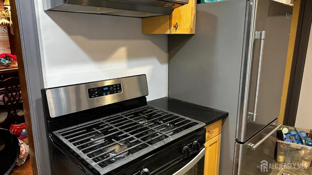 a stove top oven sitting inside of a kitchen