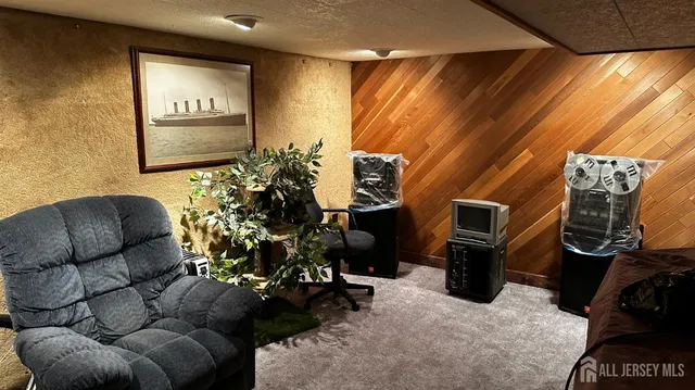 a living room with furniture a mirror and a flat screen tv