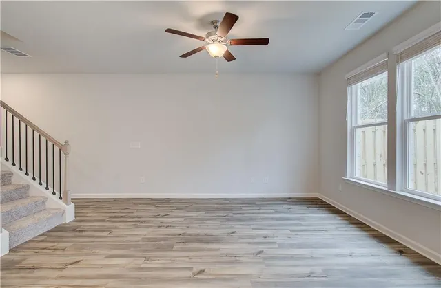 wooden floor in an empty room with a window