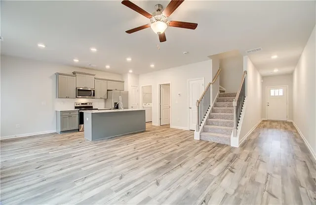 a view of kitchen with wooden floor and electronic appliances