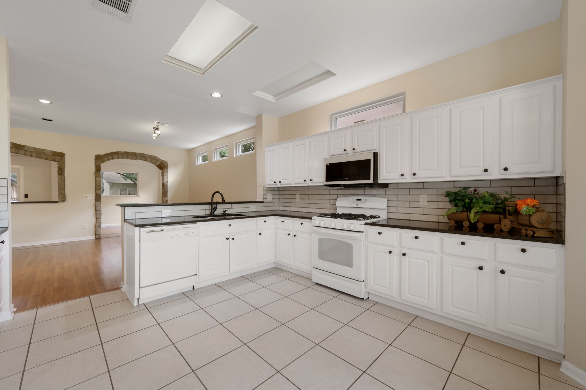 118 Bass Street Georgetown, TX 78633 - Photo 17 of 40 Culinary delights await in this bright kitchen, boasting skylights and sleek white cabinetry.