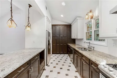 a kitchen with a sink stove and cabinets
