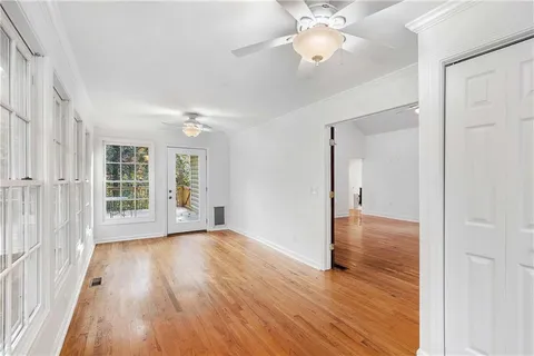 wooden floor in an empty room with a window