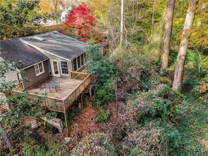 an aerial view of house with yard and seating area