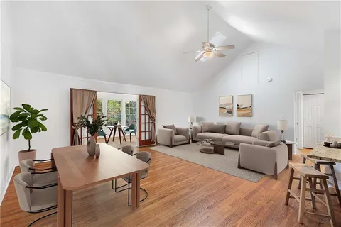 a living room with furniture and a wooden floor