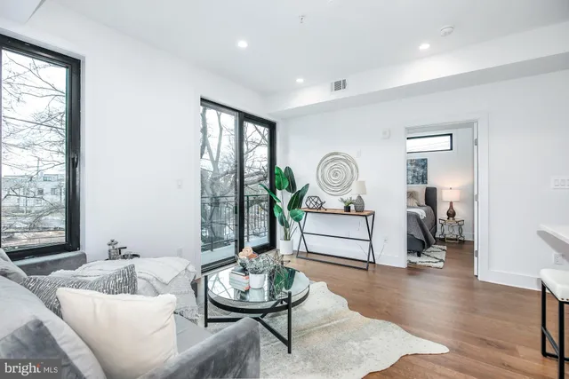 a living room with furniture and wooden floor
