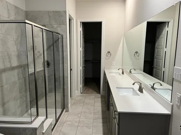 a en suite bathroom with a sink a mirror and a shower
