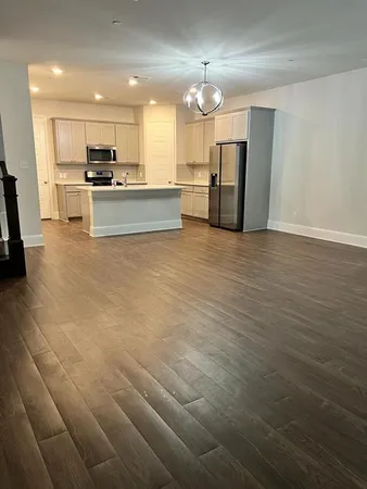 an open kitchen with a sink and stainless steel appliances