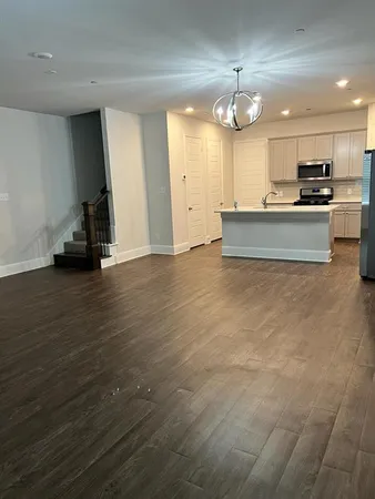 a view of a kitchen with a sink and a large mirror
