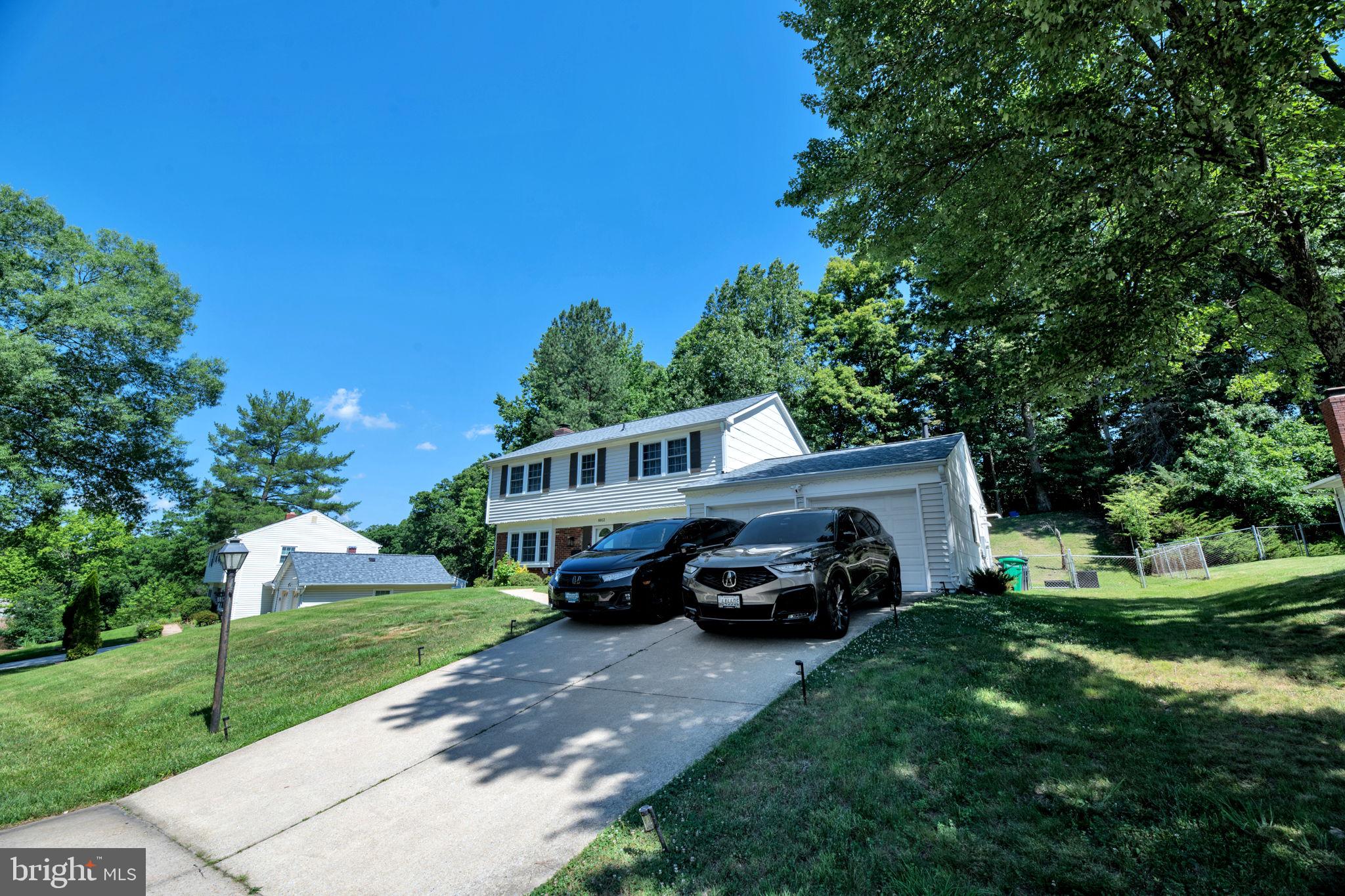 8812 Churchfield Lane Laurel, MD 20708 - Photo 27 of 31 a car parked in front of a house with a big yard