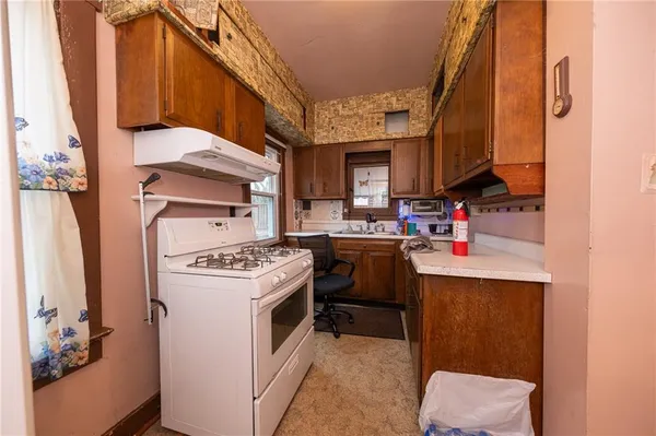 a kitchen with a stove and a refrigerator