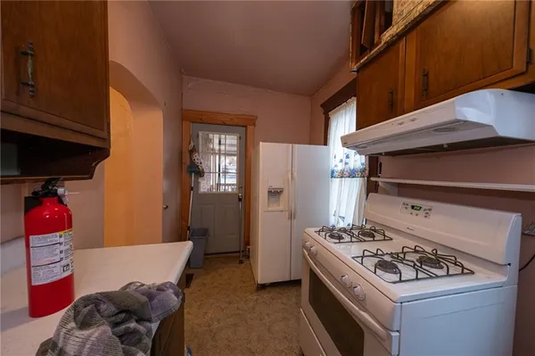 a bathroom with a shower a toilet and a sink