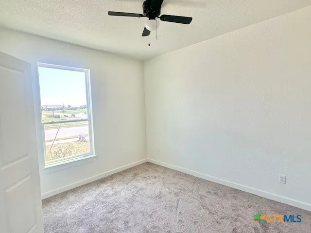 a view of an empty room and a window