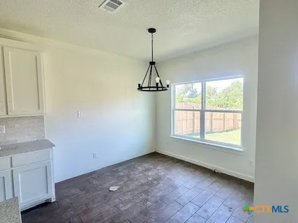 a view of a room with windows and wooden floor