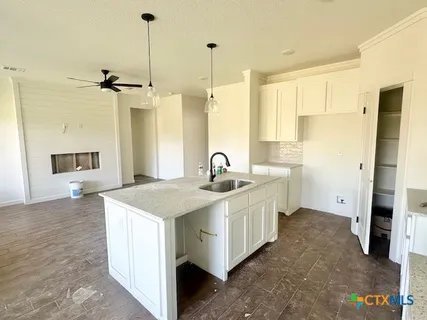 a kitchen with a sink and a refrigerator
