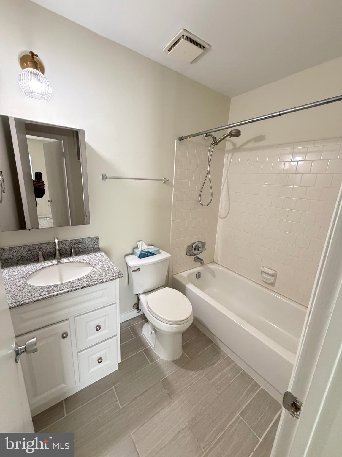 6427 Old Scotts Court Springfield, VA 22152 - Photo 11 of 27 a bathroom with a granite countertop toilet sink and mirror