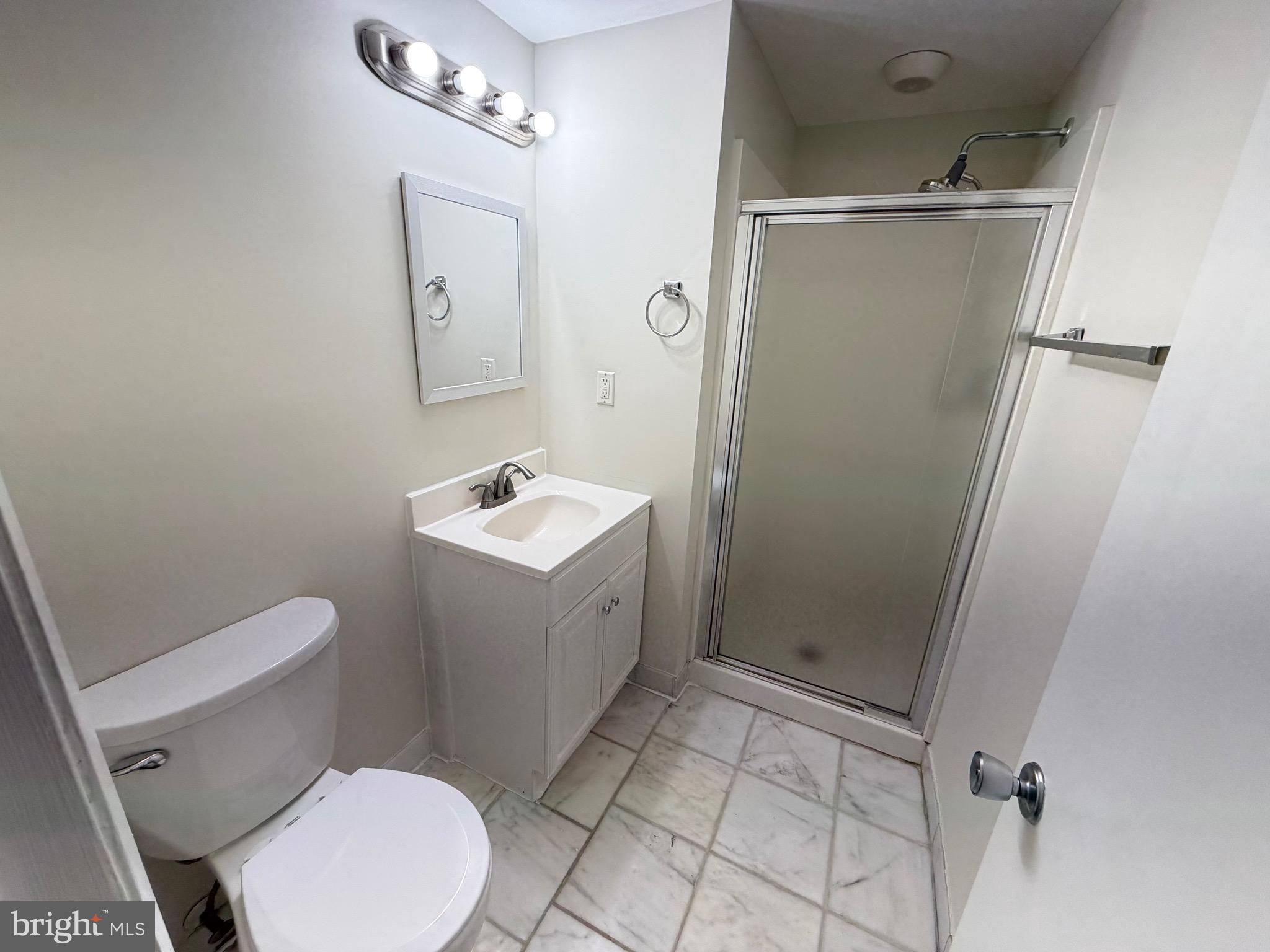 6427 Old Scotts Court Springfield, VA 22152 - Photo 21 of 27 a white toilet sitting next to a bathroom sink