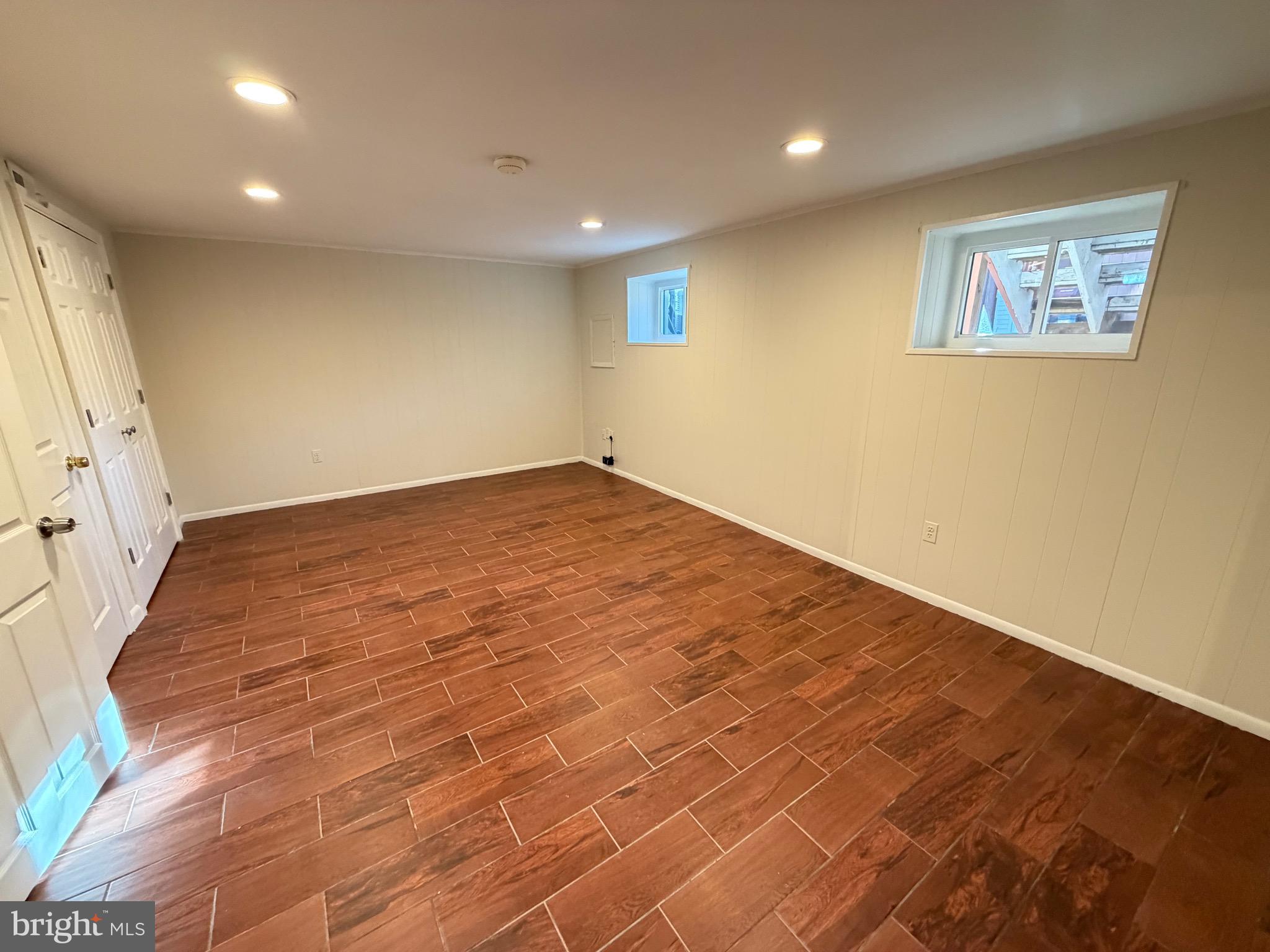 6427 Old Scotts Court Springfield, VA 22152 - Photo 23 of 27 an empty room with wooden floor and windows