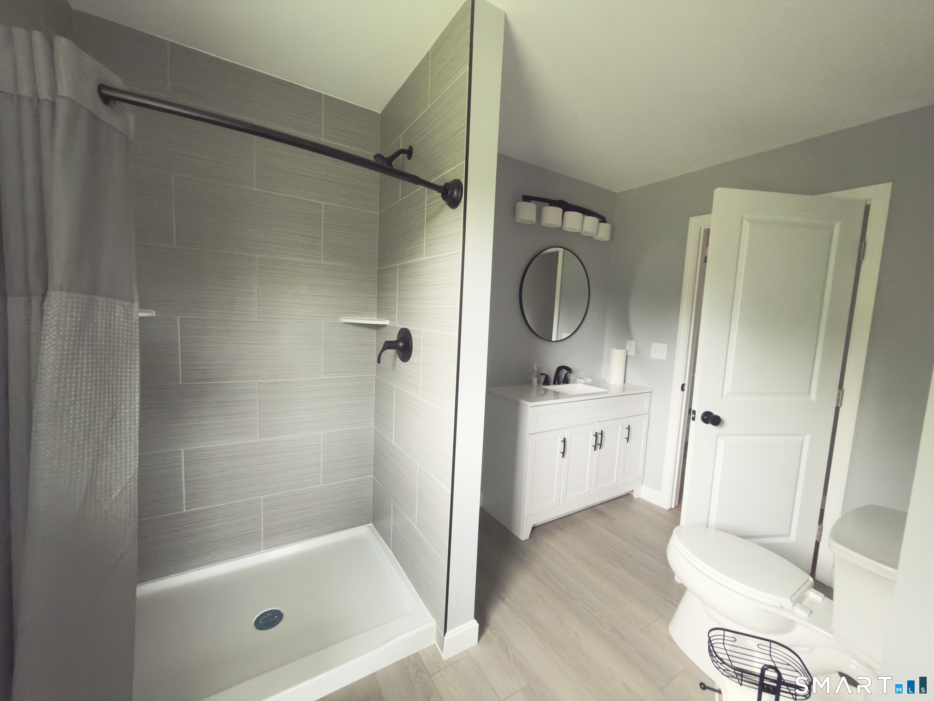 44 Polly Avenue Killingly, CT 06239 - Photo 20 of 22 a bathroom with a granite countertop shower a mirror and a sink