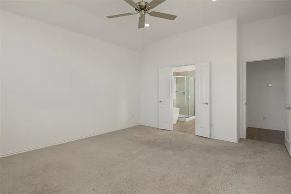 an empty room with a ceiling fan and a window