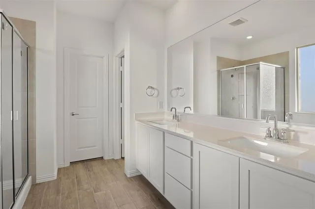 a bathroom with a double vanity sink and mirror