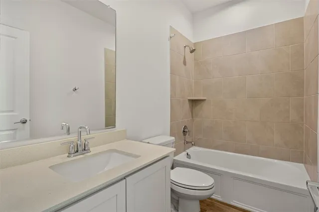 a bathroom with a sink a toilet and a bathtub