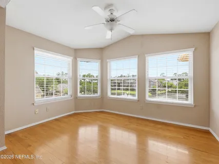 a kitchen with stainless steel appliances granite countertop a sink a stove a refrigerator and island with wooden floor