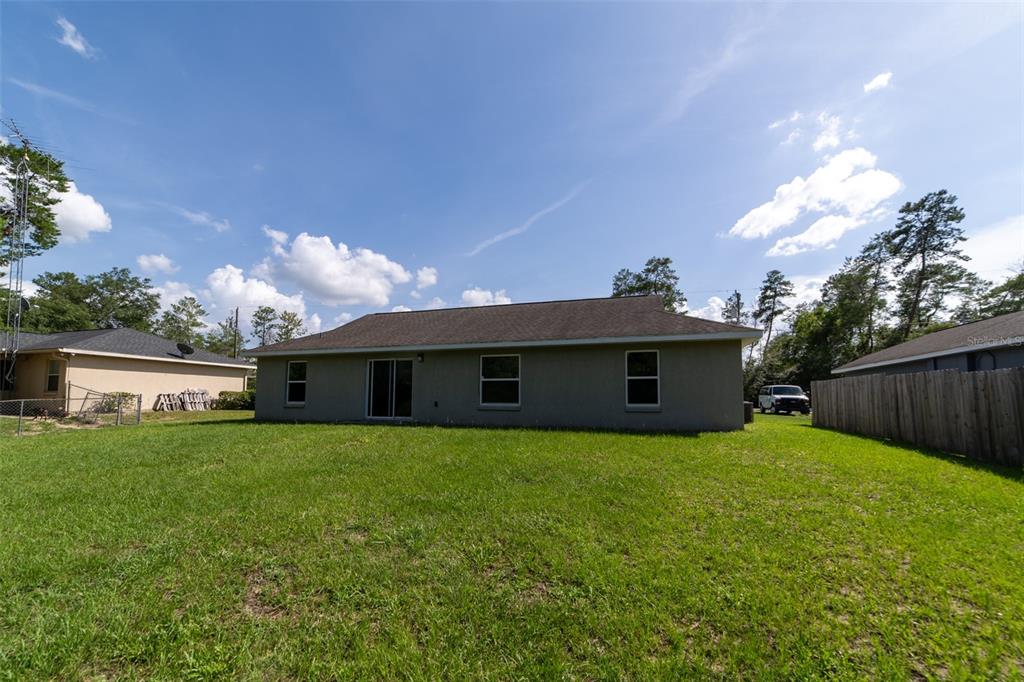 5107 Southwest 165th St Road Ocala, FL 34473 - Photo 33 of 34 a front view of house with yard and trees