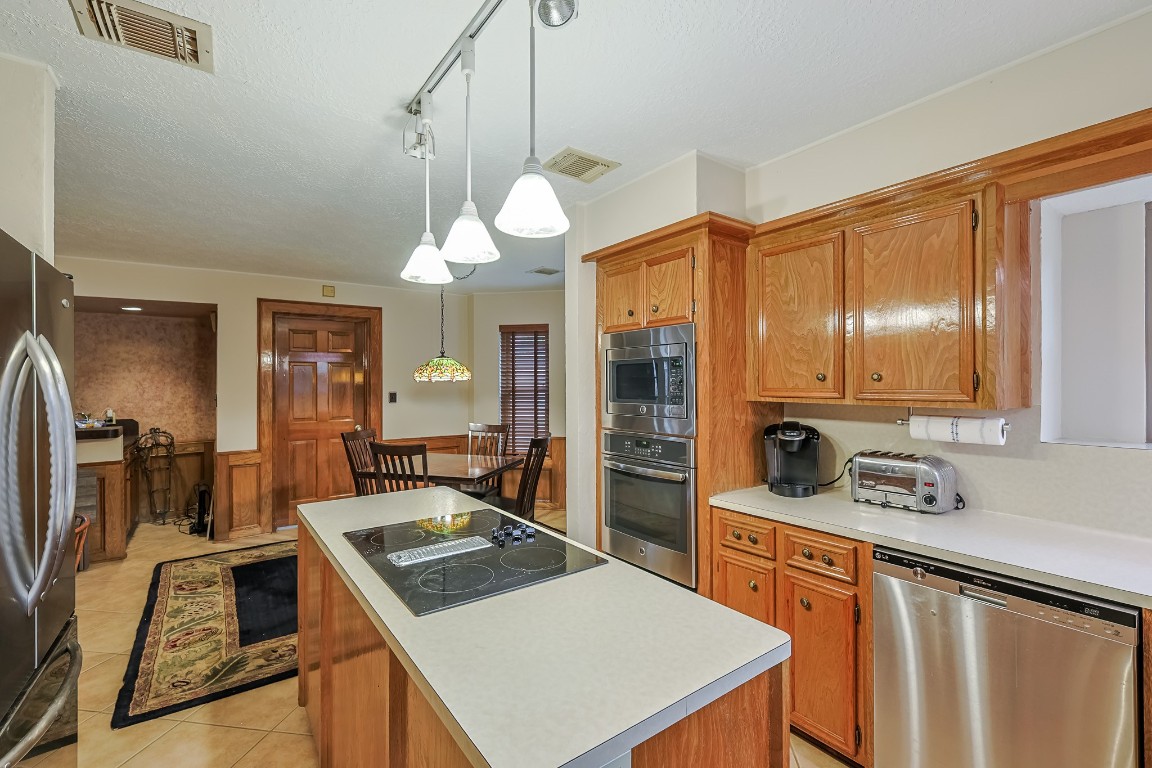 5527 Glenmere Lane Spring, TX 77379 - Photo 18 of 40 a kitchen that has a cabinets and a stove
