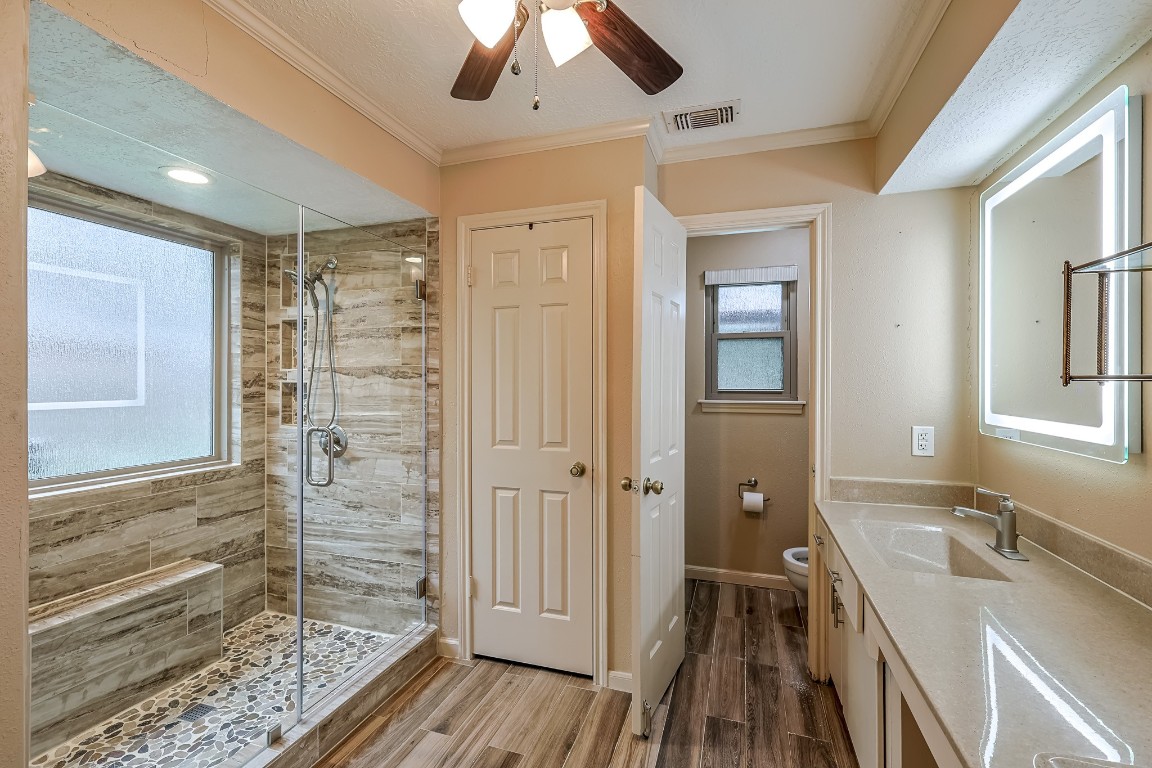 5527 Glenmere Lane Spring, TX 77379 - Photo 20 of 40 a bathroom with a double vanity sink a mirror and a shower