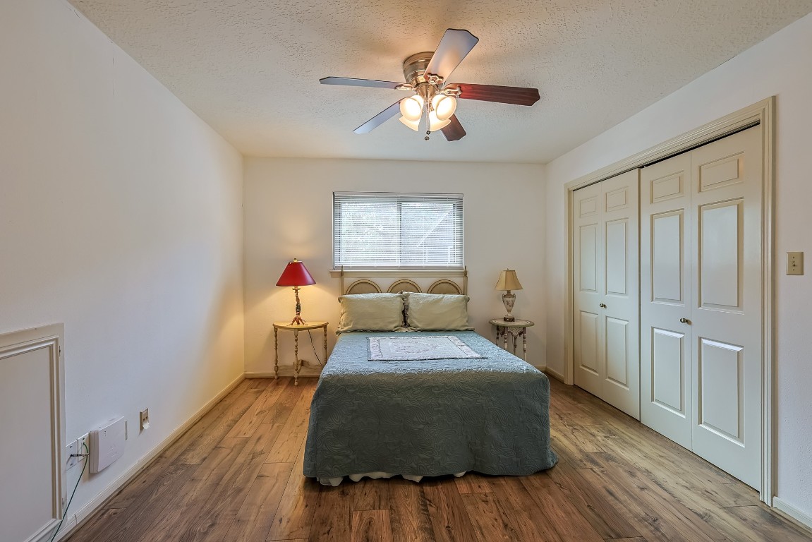 5527 Glenmere Lane Spring, TX 77379 - Photo 29 of 40 a bedroom with a bed and wooden floor