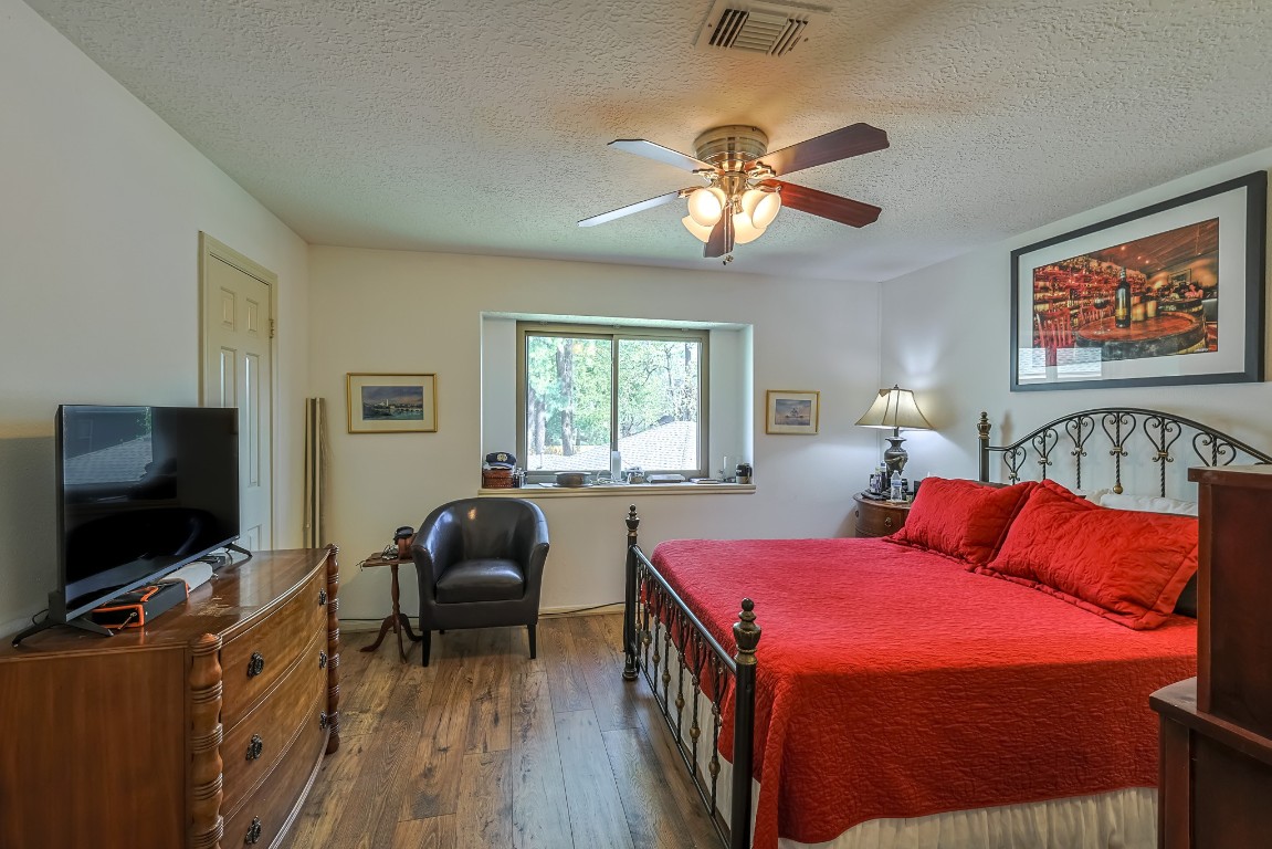 5527 Glenmere Lane Spring, TX 77379 - Photo 33 of 40 a bedroom with a bed and a flat screen tv