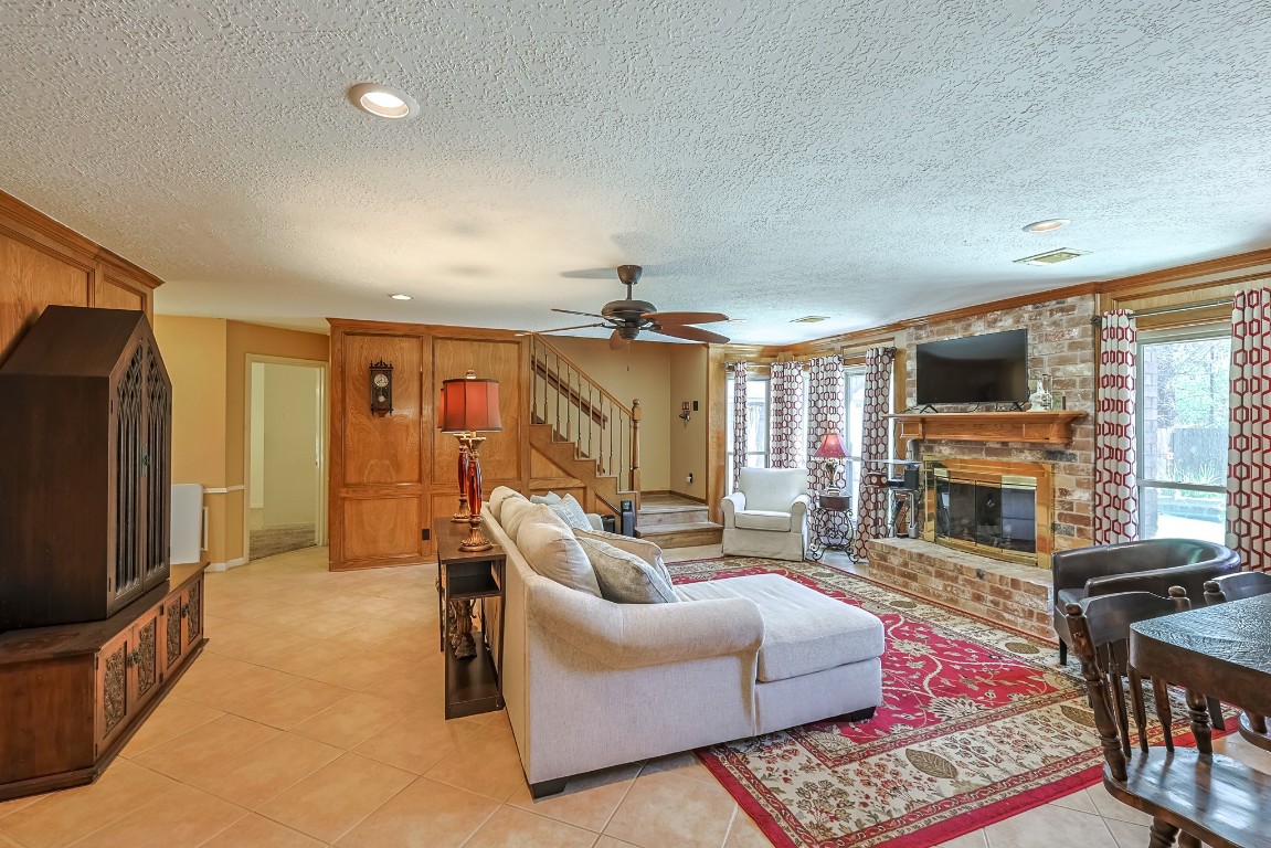 5527 Glenmere Lane Spring, TX 77379 - Photo 7 of 40 a living room with fireplace furniture and a flat screen tv