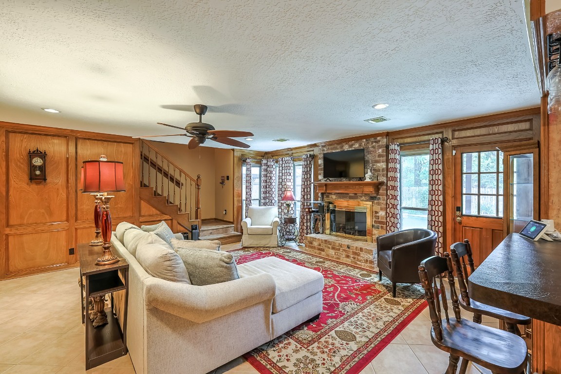 5527 Glenmere Lane Spring, TX 77379 - Photo 9 of 40 a living room with fireplace furniture and a flat screen tv