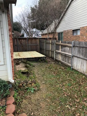 a view of a backyard with a fence