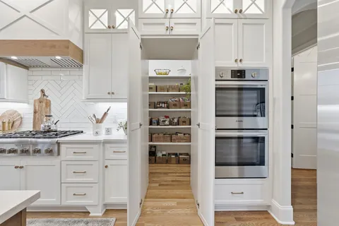 a kitchen with stainless steel appliances a stove and more cabinets