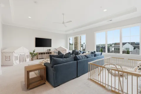 a living room with furniture and a chandelier
